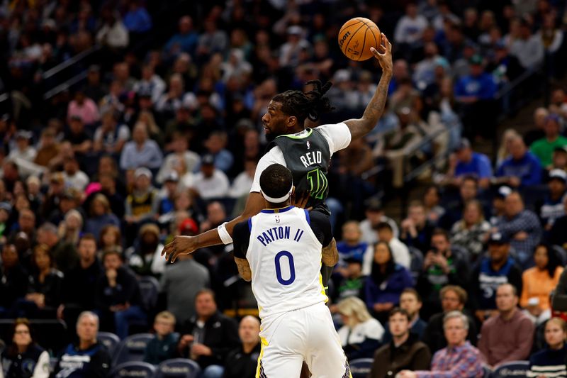 MINNEAPOLIS, MINNESOTA - MARCH 24: Kyle Anderson #1 of the Minnesota Timberwolves receives a pass against Gary Payton II #0 of the Golden State Warriors in the third quarter at Target Center on March 24, 2024 in Minneapolis, Minnesota. The Timberwolves defeated the Warriors 114-110. NOTE TO USER: User expressly acknowledges and agrees that, by downloading and or using this photograph, User is consenting to the terms and conditions of the Getty Images License Agreement. (Photo by David Berding/Getty Images)