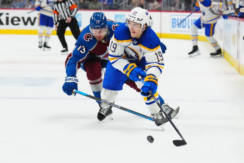 Dec 13, 2023; Denver, Colorado, USA; Buffalo Sabres center Peyton Krebs (19) skates past Colorado Avalanche right wing Valeri Nichushkin (13) in the third period at Ball Arena. Mandatory Credit: Ron Chenoy-USA TODAY Sports