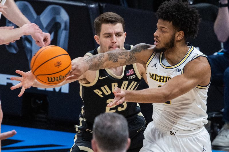 Mar 14, 2025; Indianapolis, IN, USA; Michigan Wolverines guard Roddy Gayle Jr. (11) passes the ball while Purdue Boilermakers forward Camden Heide (23) defends in the first half at Gainbridge Fieldhouse. Mandatory Credit: Trevor Ruszkowski-Imagn Images