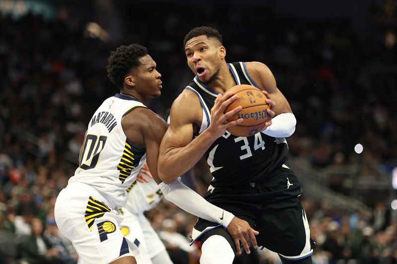 MILWAUKEE, WISCONSIN - NOVEMBER 22: Giannis Antetokounmpo #34 of the Milwaukee Bucks is defended by Bennedict Mathurin #00 of the Indiana Pacers during the second half of a game in the NBA Emirates Cup at Fiserv Forum on November 22, 2024 in Milwaukee, Wisconsin. NOTE TO USER: User expressly acknowledges and agrees that, by downloading and or using this photograph, User is consenting to the terms and conditions of the Getty Images License Agreement. (Photo by Stacy Revere/Getty Images)