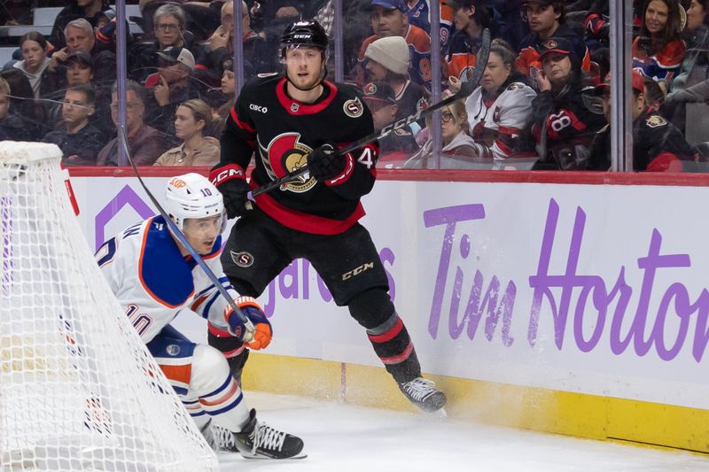 Nov 19, 2024; Ottawa, Ontario, CAN; Ottawa Senators defenseman Tyle Kleven (43) moves the puck away from Edmonton Oilers center Derek Ryan (10) in the second period at the Canadian Tire Centre. Mandatory Credit: Marc DesRosiers-Imagn Images