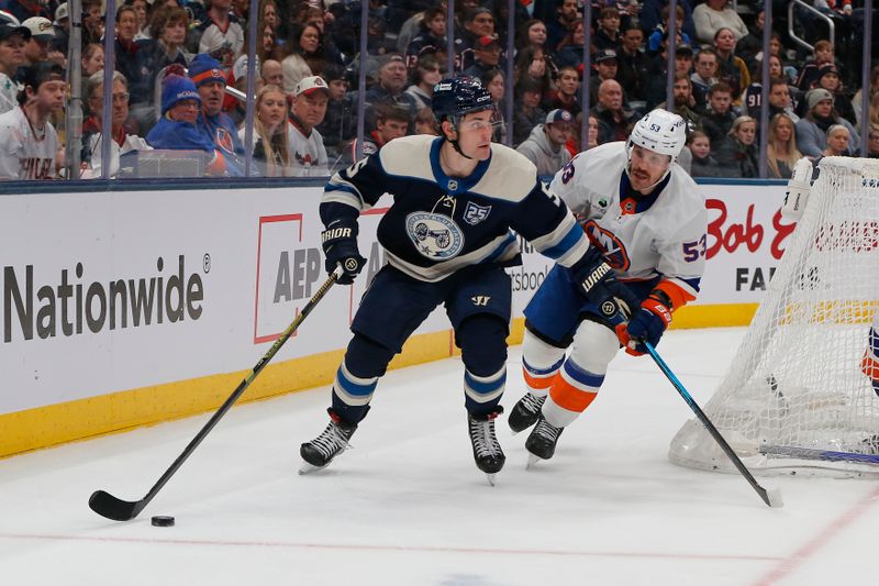 Dec 28, 2025; Columbus, Ohio, USA; Columbus Blue Jackets defenseman Denton Mateychuk (5) looks to pass as New York Islanders center Casey Cizikas (53) defends during the second period at Nationwide Arena. Mandatory Credit: Russell LaBounty-Imagn Images