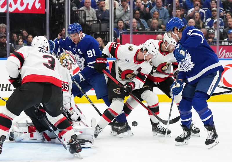 Nov 12, 2024; Toronto, Ontario, CAN; Toronto Maple Leafs center John Tavares (91) battles for the puck with Ottawa Senators defenseman Thomas Chabot (72) during the first period at Scotiabank Arena. Mandatory Credit: Nick Turchiaro-Imagn Images