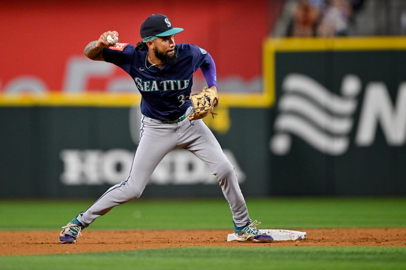 Jun 28, 2025; Arlington, Texas, USA; Seattle Mariners shortstop J.P. Crawford (3) throws to first base during the third inning against the Texas Rangers at Globe Life Field. Mandatory Credit: Jerome Miron-Imagn Images