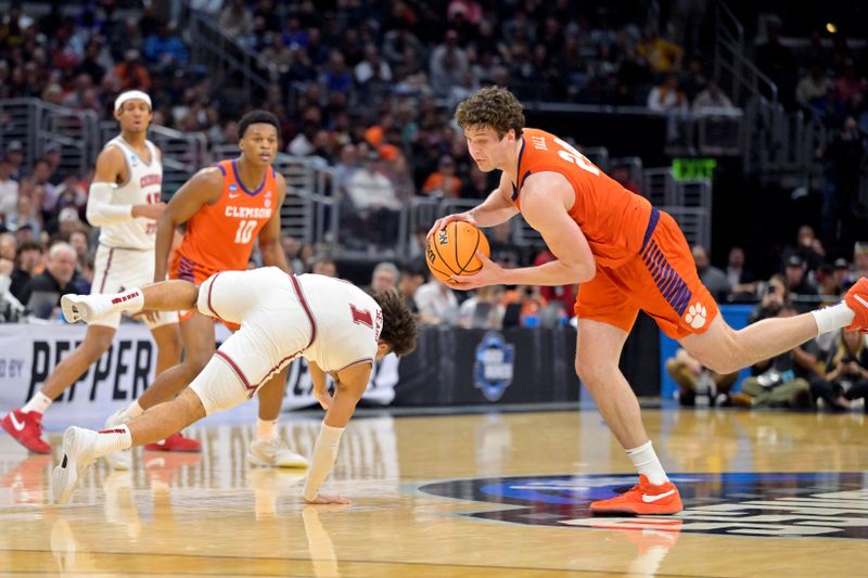 Mar 30, 2024; Los Angeles, CA, USA; Clemson Tigers center PJ Hall (24) controls the ball against Alabama Crimson Tide guard Mark Sears (1) in the second half in the finals of the West Regional of the 2024 NCAA Tournament at Crypto.com Arena. Mandatory Credit: Jayne Kamin-Oncea-USA TODAY Sports