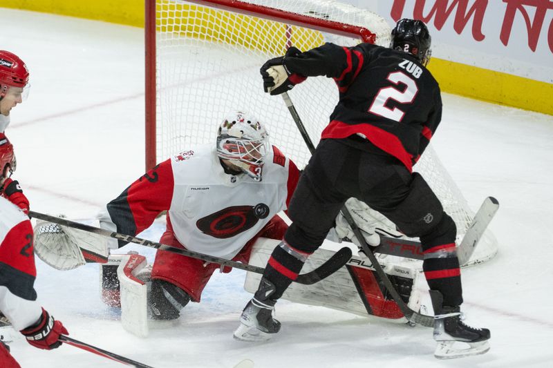 Jan 24, 2026; Ottawa, Ontario, CAN; Carolina Hurricanes goalie Brandon Bussi (32) makes a save on a shot from Ottawa Senators defenseman Artem Zub (2) in the third period at the Canadian Tire Centre. Mandatory Credit: Marc DesRosiers-IMAGN Images