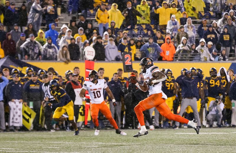 Oct 21, 2023; Morgantown, West Virginia, USA; Oklahoma State Cowboys running back Ollie Gordon II (0) runs for a touchdown during the fourth quarter against the West Virginia Mountaineers at Mountaineer Field at Milan Puskar Stadium. Mandatory Credit: Ben Queen-USA TODAY Sports