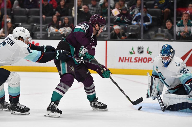 Dec 23, 2023; Anaheim, California, USA; Seattle Kraken goaltender Joey Daccord (35) blocks a shot against Anaheim Ducks center Mason McTavish (23) during the second period at Honda Center. Mandatory Credit: Gary A. Vasquez-USA TODAY Sports