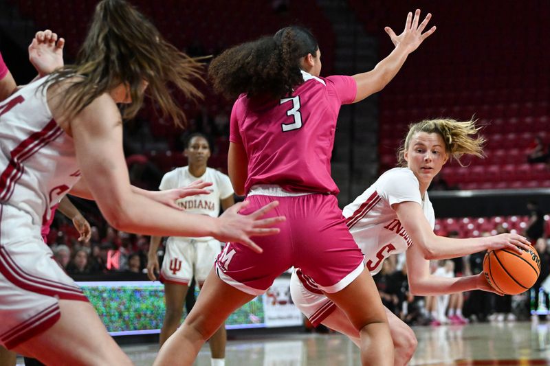 Jan 31, 2024; College Park, Maryland, USA; Indiana Hoosiers guard Lenee Beaumont (5) passes around Maryland Terrapins guard Lavender Briggs (3) to forward Mackenzie Holmes (54) during the fist half  at Xfinity Center. Mandatory Credit: Tommy Gilligan-USA TODAY Sports