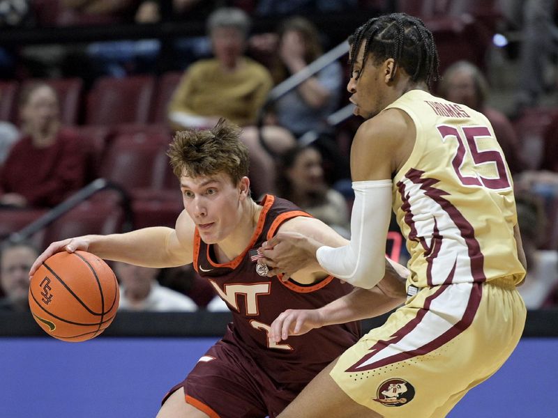 Jan 29, 2025; Tallahassee, Florida, USA; Virginia Tech Hokies guard Jaden Schutt (2) maneuvers around Florida State Seminoles guard Justin Thomas (25) during the first half at Donald L. Tucker Center. Mandatory Credit: Melina Myers-Imagn Images