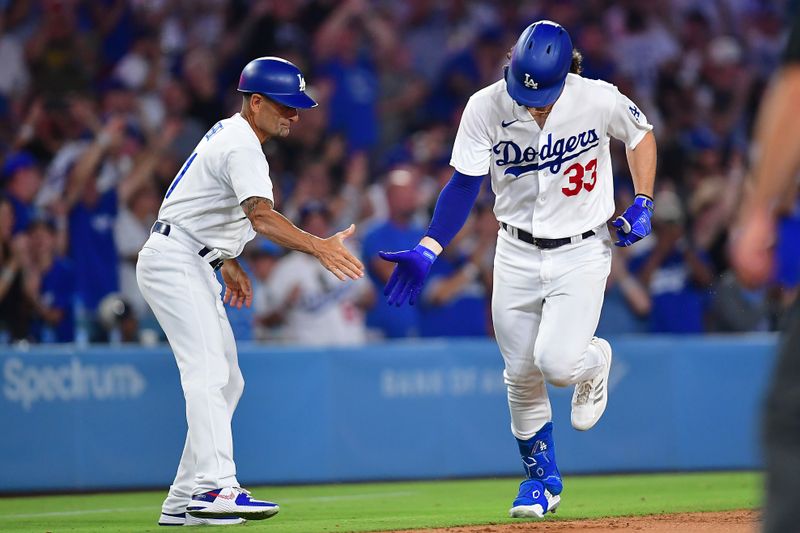 Aug 28, 2023; Los Angeles, California, USA; Los Angeles Dodgers center fielder James Outman (33) is greeted by third base coach Dino Ebel (91) after hitting a solo home run against the Arizona Diamondbacks during the sixth inning at Dodger Stadium. Mandatory Credit: Gary A. Vasquez-USA TODAY Sports