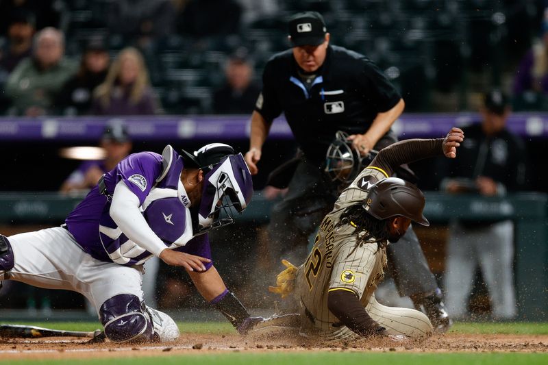 Apr 22, 2024; Denver, Colorado, USA; San Diego Padres catcher Luis Campusano (12) slides safely past Colorado Rockies catcher Elias Diaz (35) on an RBI in the eighth inning at Coors Field. Mandatory Credit: Isaiah J. Downing-USA TODAY Sports