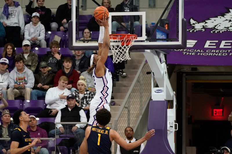 Jan 31, 2023; Fort Worth, Texas, USA; TCU Horned Frogs forward Xavier Cork (12) scores a layup over West Virginia Mountaineers forward Emmitt Matthews Jr. (1) during the second half at Ed and Rae Schollmaier Arena. Mandatory Credit: Chris Jones-USA TODAY Sports