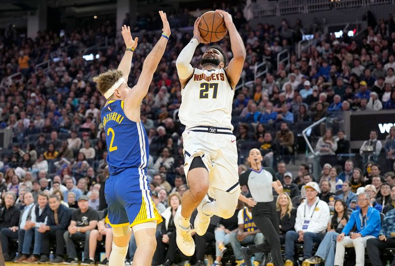 SAN FRANCISCO, CALIFORNIA - JANUARY 04: Jamal Murray #27 of the Denver Nuggets shoots the ball against Brandin Podziemski #2 of the Golden State Warriors during the third quarter at Chase Center on January 04, 2024 in San Francisco, California. NOTE TO USER: User expressly acknowledges and agrees that, by downloading and or using this photograph, User is consenting to the terms and conditions of the Getty Images License Agreement. (Photo by Thearon W. Henderson/Getty Images)