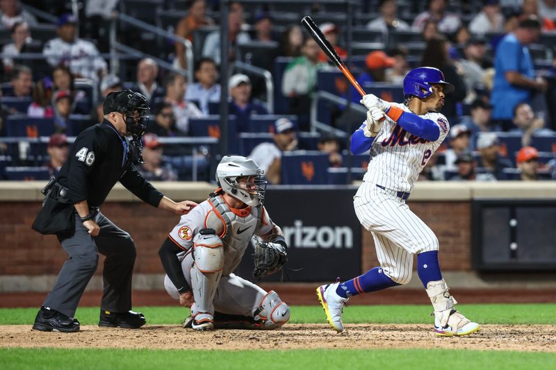 Aug 20, 2024; New York City, New York, USA;  New York Mets shortstop Francisco Lindor (12) hits a double in the eighth inning against the Baltimore Orioles at Citi Field. Mandatory Credit: Wendell Cruz-USA TODAY Sports