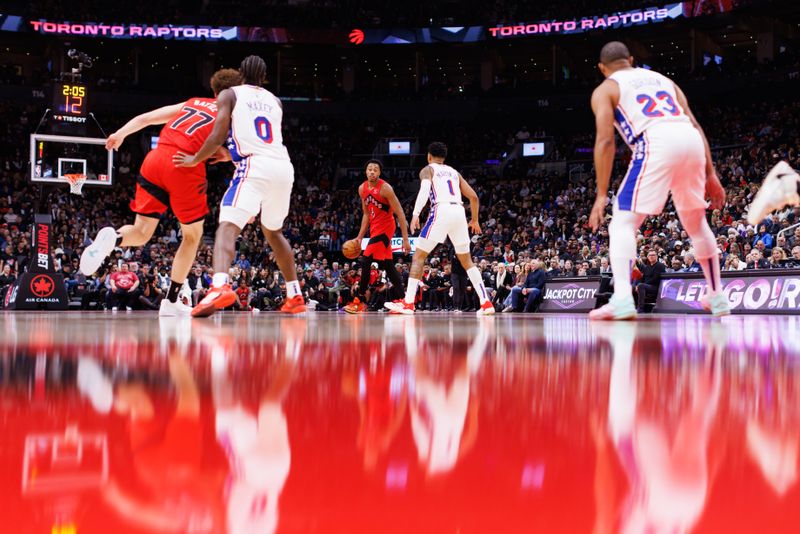 TORONTO, CANADA - OCTOBER 25: Scottie Barnes #4 of the Toronto Raptors dribbles against KJ Martin #1 of the Philadelphia 76ers of the Philadelphia 76ers during the second half of their NBA game at Scotiabank Arena on October 25, 2024 in Toronto, Ontario, Canada. NOTE TO USER: User expressly acknowledges and agrees that, by downloading and or using this photograph, User is consenting to the terms and conditions of the Getty Images License Agreement. (Photo by Cole Burston/Getty Images)