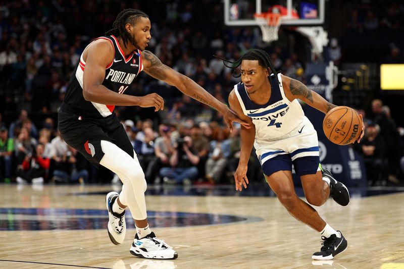 MINNEAPOLIS, MINNESOTA - NOVEMBER 08: Rob Dillingham #4 of the Minnesota Timberwolves drives to the basket against Jabari Walker #34 of the Portland Trail Blazers in the fourth quarter at Target Center on November 08, 2024 in Minneapolis, Minnesota. The Timberwolves defeated the Trail Blazers 127-102 NOTE TO USER: User expressly acknowledges and agrees that, by downloading and or using this photograph, User is consenting to the terms and conditions of the Getty Images License Agreement. (Photo by David Berding/Getty Images)