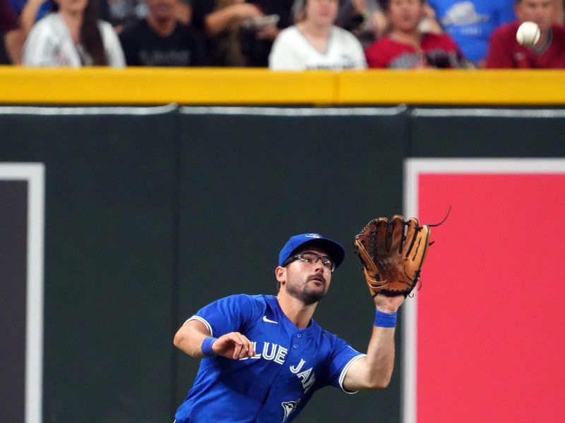 Jul 13, 2024; Phoenix, Arizona, USA; Toronto Blue Jays outfielder Davis Schneider (36) runs down a fly ball against the Arizona Diamondbacks during the sixth inning at Chase Field. Mandatory Credit: Joe Camporeale-USA TODAY Sports