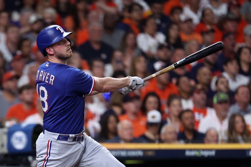 Oct 22, 2023; Houston, Texas, USA; Texas Rangers catcher Mitch Garver (18) hits a home run against the Houston Astros in the second inning during game six of the ALCS for the 2023 MLB playoffs at Minute Maid Park. Mandatory Credit: Troy Taormina-USA TODAY Sports