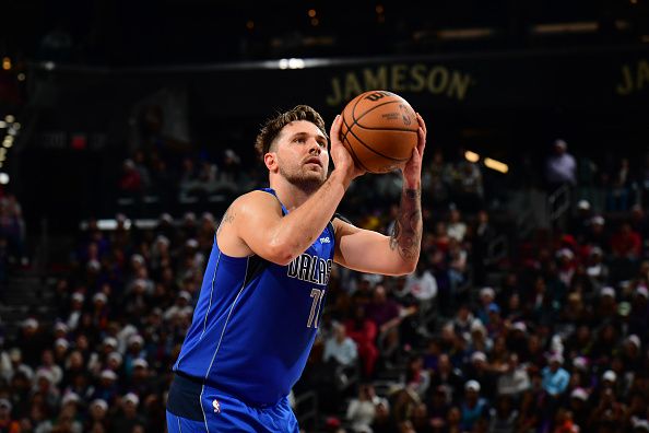 PHOENIX, AZ - DECEMBER 25: Luka Doncic #77 of the Dallas Mavericks shoots a free throw during the game against the Phoenix Suns on December 25, 2023 at Footprint Center in Phoenix, Arizona. NOTE TO USER: User expressly acknowledges and agrees that, by downloading and or using this photograph, user is consenting to the terms and conditions of the Getty Images License Agreement. Mandatory Copyright Notice: Copyright 2023 NBAE (Photo by Kate Frese/NBAE via Getty Images)