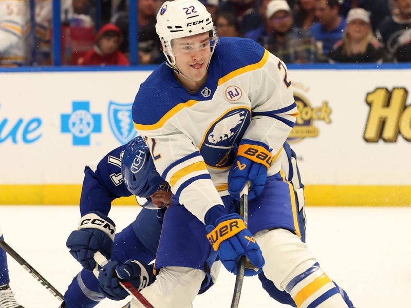 Apr 15, 2024; Tampa, Florida, USA; Buffalo Sabres right wing Jack Quinn (22) passes the puck as Tampa Bay Lightning center Anthony Cirelli (71) defends during the second period at Amalie Arena. Mandatory Credit: Kim Klement Neitzel-USA TODAY Sports