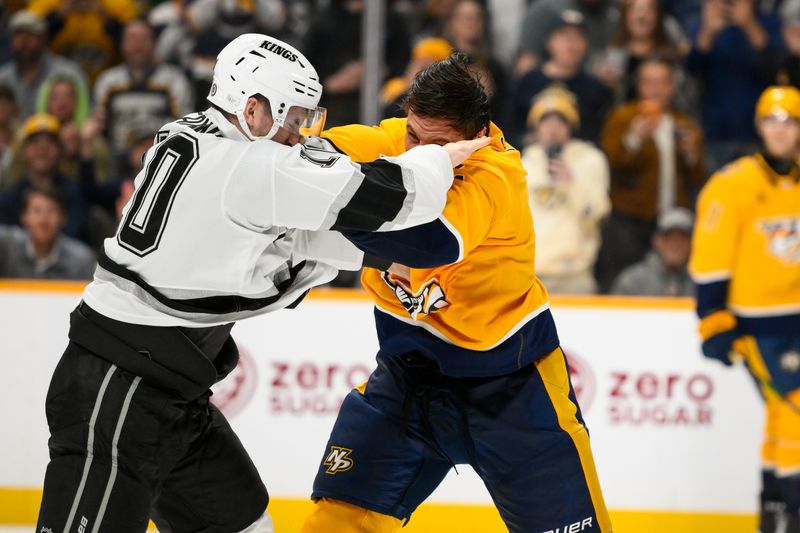 Nov 4, 2024; Nashville, Tennessee, USA;  Los Angeles Kings left wing Tanner Jeannot (10) and Nashville Predators defenseman Luke Schenn (2) exchange blows during the second period at Bridgestone Arena. Mandatory Credit: Steve Roberts-Imagn Images