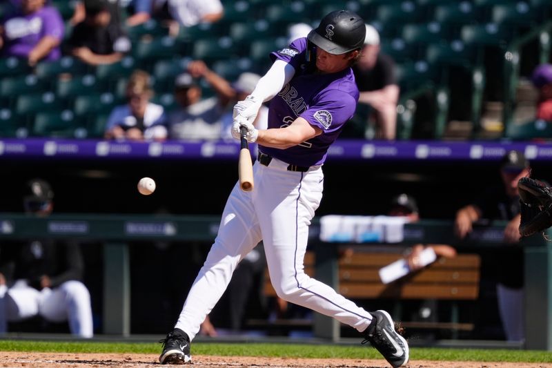 Aug 17, 2025; Denver, Colorado, USA; Colorado Rockies outfielder Mickey Moniak (22) hits a two run single in the seventh inning against the Arizona Diamondbacks at Coors Field. Mandatory Credit: Ron Chenoy-Imagn Images