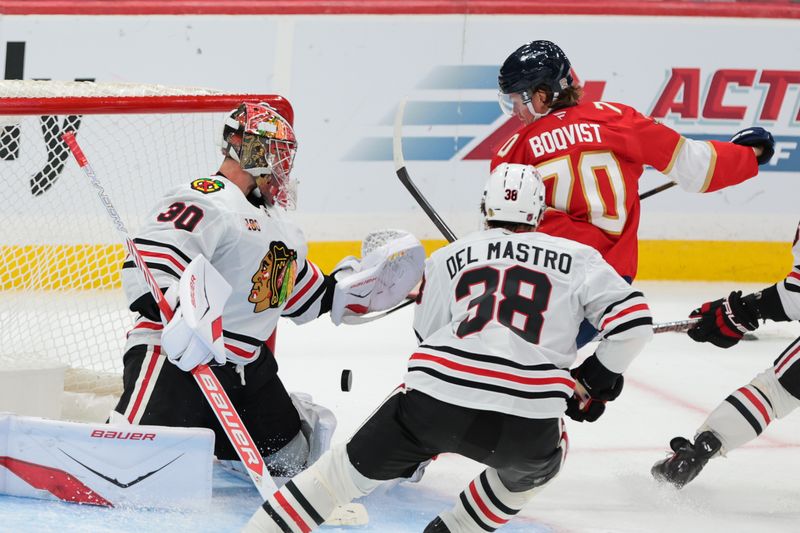 Oct 7, 2025; Sunrise, Florida, USA; Florida Panthers center Jesper Boqvist (70) scores against Chicago Blackhawks goaltender Spencer Knight (30) during the third period at Amerant Bank Arena. Mandatory Credit: Sam Navarro-Imagn Images