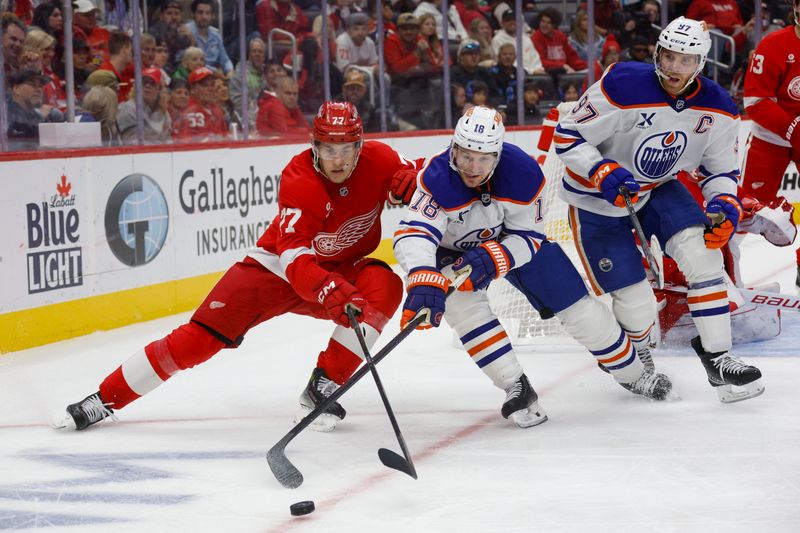 Oct 27, 2024; Detroit, Michigan, USA; Detroit Red Wings defenseman Simon Edvinsson (77) fights for control of the puck against Edmonton Oilers left wing Zach Hyman (18) during the third period at Little Caesars Arena. Mandatory Credit: Brian Bradshaw Sevald-Imagn Images