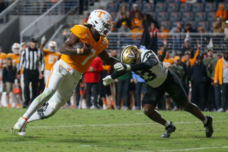 Nov 25, 2023; Knoxville, Tennessee, USA; Tennessee Volunteers quarterback Joe Milton III (7) runs for a touchdown against Vanderbilt Commodores defensive back Jaylen Mahoney (23) during the second half at Neyland Stadium. Mandatory Credit: Randy Sartin-USA TODAY Sports