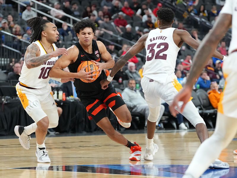 Mar 8, 2023; Las Vegas, NV, USA; Oregon State Beavers guard Dexter Akanno (4) drives between Arizona State Sun Devils guard Frankie Collins (10) and forward Alonzo Gaffney (32) during the second half at T-Mobile Arena. Mandatory Credit: Stephen R. Sylvanie-USA TODAY Sports