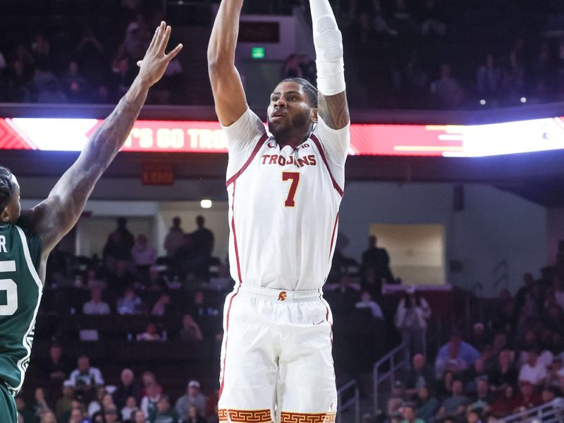 Feb 1, 2025; Los Angeles, California, USA;  USC Trojans guard Chibuzo Agbo (7) goes for a jump shot against the Michigan State Spartans during the first half at Galen Center. Mandatory Credit: William Navarro-Imagn Images