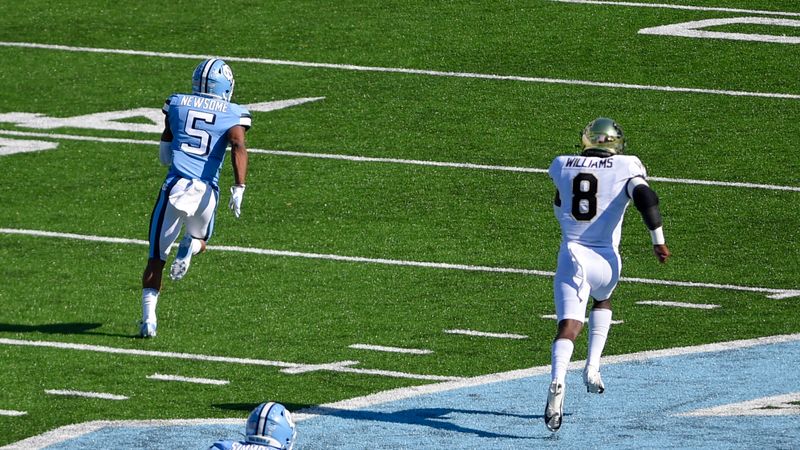 Nov 14, 2020; Chapel Hill, North Carolina, USA; North Carolina Tar Heels wide receiver Dazz Newsome (5) catches a pass and runs for a touchdown as Wake Forest Demon Deacons linebacker Ja'Cquez Williams (8) defends in the first quarter at Kenan Memorial Stadium. Mandatory Credit: Bob Donnan-USA TODAY Sports