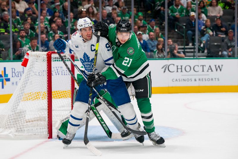 Oct 26, 2023; Dallas, Texas, USA; Toronto Maple Leafs center John Tavares (91) and Dallas Stars left wing Jason Robertson (21) battle for position in the Stars crease during the first period at the American Airlines Center. Mandatory Credit: Jerome Miron-USA TODAY Sports