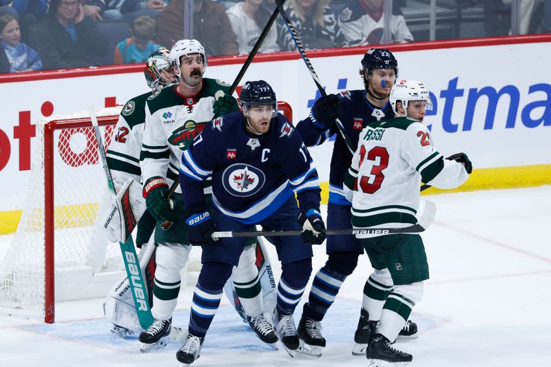 Oct 13, 2024; Winnipeg, Manitoba, CAN;  Winnipeg Jets forwards Adam Lowry (17) and Mason Appleton (22), Minnesota Wild defenseman Jake Middleton (5) and forward Marco Rossi(23) jostle for position in front of Minnesota Wild goalie Filip Gustavsson (32) during the third period at Canada Life Centre. Mandatory Credit: Terrence Lee-Imagn Images