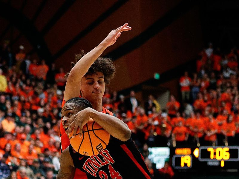 Jan 19, 2024; Fort Collins, Colorado, USA; UNLV Rebels guard Jackie Johnson III (24) drives to the basket against Colorado State Rams guard Kyan Evans (0) in the first half at Moby Arena. Mandatory Credit: Isaiah J. Downing-USA TODAY Sports