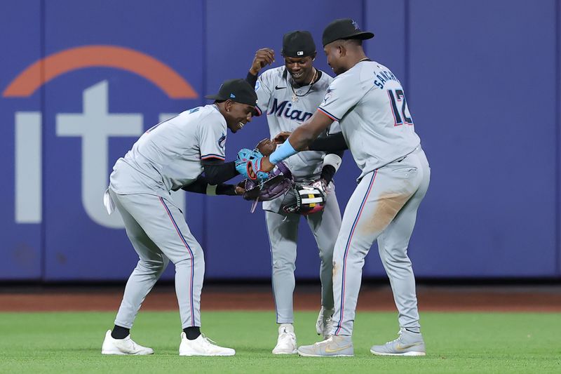 Jun 11, 2024; New York City, New York, USA; Miami Marlins left fielder Nick Gordon (1) and center fielder Jazz Chisolm Jr. (2) and right fielder Jesus Sanchez (12) celebrate after defeating the New York Mets at Citi Field. Mandatory Credit: Brad Penner-USA TODAY Sports