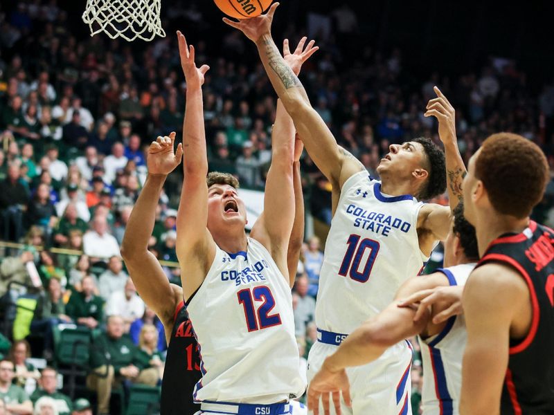 Jan 30, 2024; Fort Collins, Colorado, USA; Colorado State Rams guard Nique Clifford (10) pulls in a rebound over San Diego State Aztecs offense during the first half at Moby Arena. Mandatory Credit: Chet Strange-USA TODAY Sports