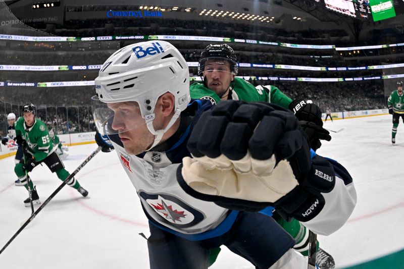 Apr 10, 2025; Dallas, Texas, USA; Winnipeg Jets left wing Nikolaj Ehlers (27) and Dallas Stars defenseman Ilya Lyubushkin (46) chase the puck during the first period at the American Airlines Center. Mandatory Credit: Jerome Miron-Imagn Images
