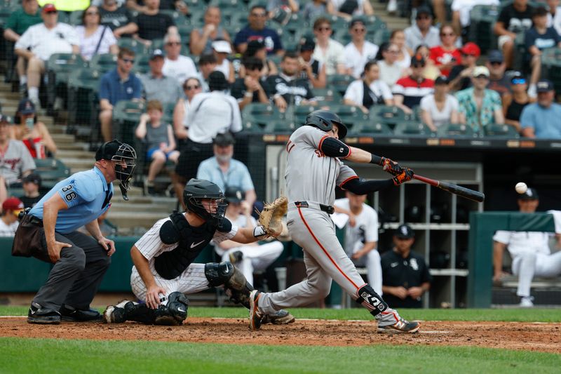 Jun 29, 2025; Chicago, Illinois, USA; San Francisco Giants right fielder Mike Yastrzemski (5) singles against the Chicago White Sox during the fifth inning at Rate Field. Mandatory Credit: Kamil Krzaczynski-Imagn Images