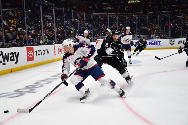 Mar 16, 2023; Los Angeles, California, USA; Columbus Blue Jackets right wing Mathieu Olivier (24) moves the puck against Los Angeles Kings defenseman Alexander Edler (2) during the third period at Crypto.com Arena. Mandatory Credit: Gary A. Vasquez-USA TODAY Sports