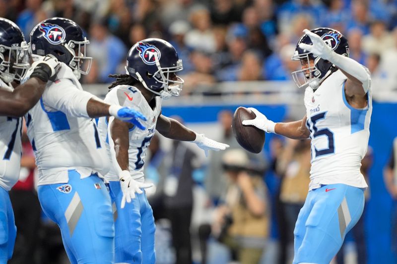 Tennessee Titans wide receiver Nick Westbrook-Ikhine, right, celebrates a touchdown with teammates during the first half of an NFL football game against the Detroit Lions, Sunday, Oct. 27, 2024, in Detroit. (AP Photo/Carlos Osorio)