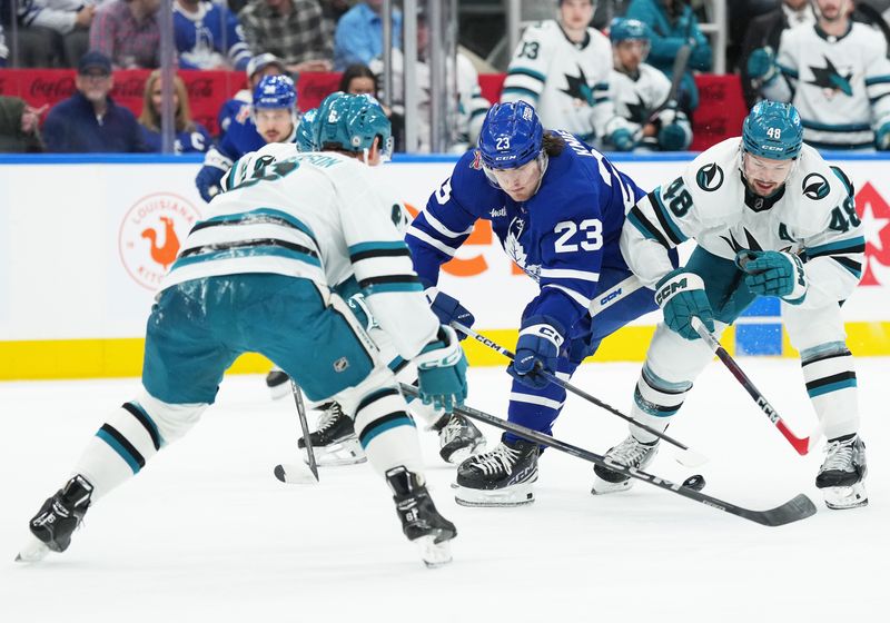 Jan 9, 2024; Toronto, Ontario, CAN; Toronto Maple Leafs left wing Matthew Knies (23) battles for the puck with San Jose Sharks center Tomas Hertl (48) during the first period at Scotiabank Arena. Mandatory Credit: Nick Turchiaro-USA TODAY Sports