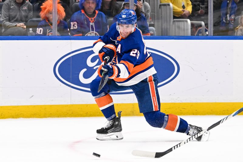 Mar 23, 2024; Elmont, New York, USA;  New York Islanders center Brock Nelson (29) attempts a shot against the Winnipeg Jets during the second period at UBS Arena. Mandatory Credit: Dennis Schneidler-USA TODAY Sports