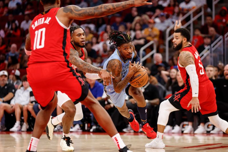 HOUSTON, TEXAS - OCTOBER 25: Ja Morant #12 of the Memphis Grizzlies drives to the basket while defended by Cam Whitmore #7 of the Houston Rockets in the second half at Toyota Center on October 25, 2024 in Houston, Texas.  NOTE TO USER: User expressly acknowledges and agrees that, by downloading and or using this photograph, User is consenting to the terms and conditions of the Getty Images License Agreement.  (Photo by Tim Warner/Getty Images)