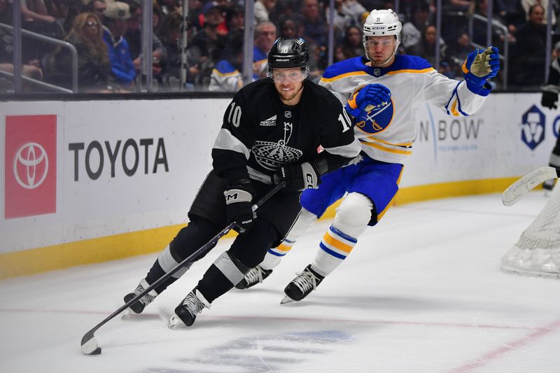 Mar 21, 2026; Los Angeles, California, USA; Los Angeles Kings left wing Artemi Panarin (10) moves the puck against Buffalo Sabres center Josh Norris (9) during the first period at Crypto.com Arena. Mandatory Credit: Gary A. Vasquez-Imagn Images