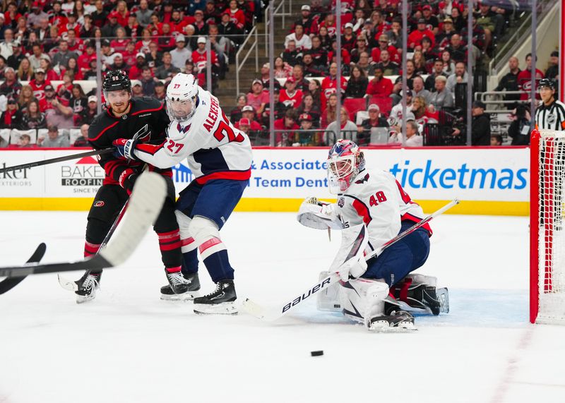 May 12, 2025; Raleigh, North Carolina, USA; Washington Capitals goaltender Logan Thompson (48) and defenseman Alexander Alexeyev (27) watch the shot against Carolina Hurricanes center Jack Roslovic (96) during the first period in game four of the second round of the 2025 Stanley Cup Playoffs at Lenovo Center. Mandatory Credit: James Guillory-Imagn Images