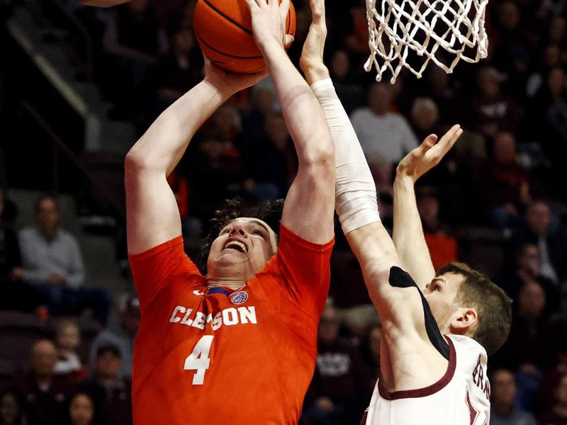 Jan 10, 2024; Blacksburg, Virginia, USA; Clemson Tigers forward Ian Schieffelin (4) shoots the ball against Virginia Tech Hokies forward Robbie Beran (31) during the first half at Cassell Coliseum. Mandatory Credit: Peter Casey-USA TODAY Sports