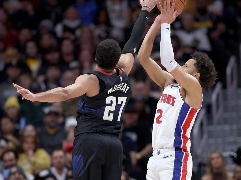 DENVER, COLORADO - JANUARY 07: Cade Cunningham #2 of the Detroit Pistons is blocked by Jamal Murray #27 of the Denver Nuggets in the first quarter at Ball Arena on January 07, 2024 in Denver, Colorado. NOTE TO USER: User expressly acknowledges and agrees that, by downloading and or using this photograph, User is consenting to the terms and conditions of the Getty Images License Agreement.  (Photo by Matthew Stockman/Getty Images)