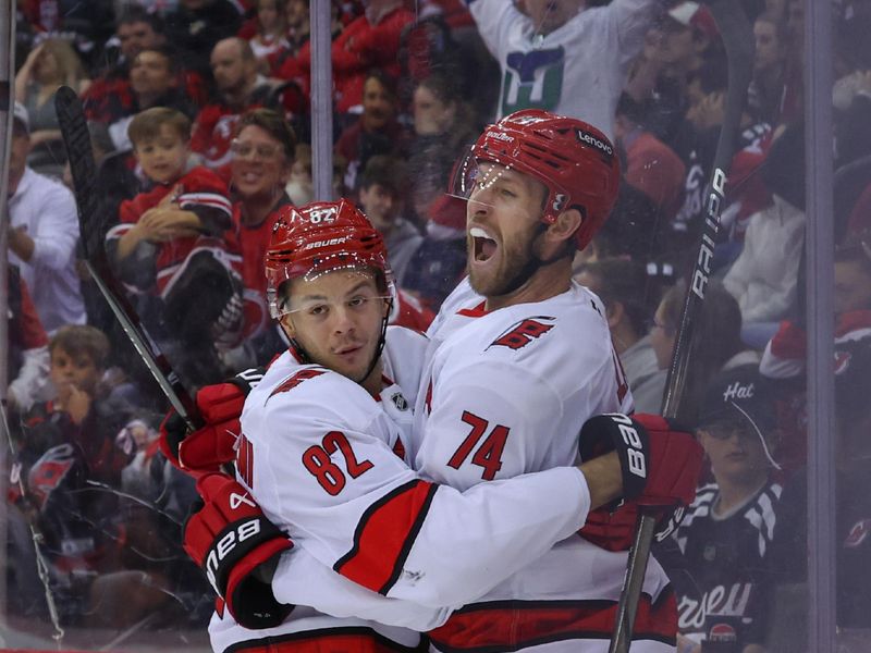 Apr 27, 2025; Newark, New Jersey, USA; Carolina Hurricanes defenseman Jaccob Slavin (74) celebrates his goal against the New Jersey Devils during the first period in game four of the first round of the 2025 Stanley Cup Playoffs at Prudential Center. Mandatory Credit: Ed Mulholland-Imagn Images